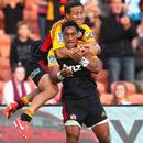 The Chiefs' Bundee Aki (front) celebrates his try against the Reds with Tim Nanai-Williams
