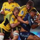 The Blues' Francis Saili is wrestled to the ground