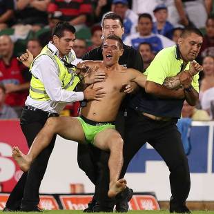 A man is taken from the field by security at nib Stadium, Force v Crusaders, Super Rugby, nib Stadium, Perth, April 13, 2013