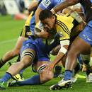 Alapati Leiua of the Hurricanes is tackled just short of the tryline