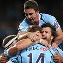 Cam Crawford of the Waratahs celebrates with team-mates after scoring a try