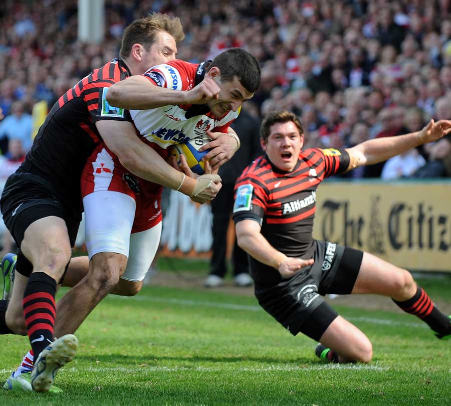 Gloucester's Jonny May fights his way to the Saracens try line