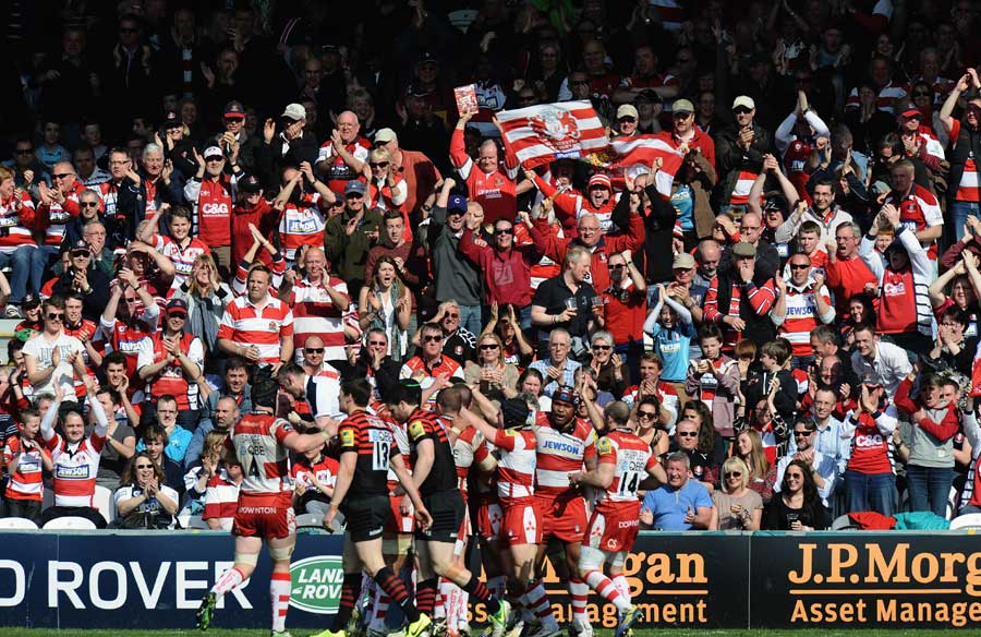 Gloucester celebrate in front of a wall of cherry and white