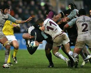 Worcester's Dale Rasmussen is tackled by Bourgoin's Jean-Francois Coux during their European Challenge Cup clash at Sixways Stadium in Worcester, England on December 13, 2008. 