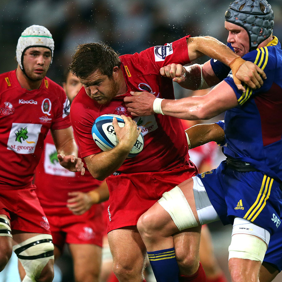 Queensland Reds prop Greg Holmes attempts to shrug off a tackle