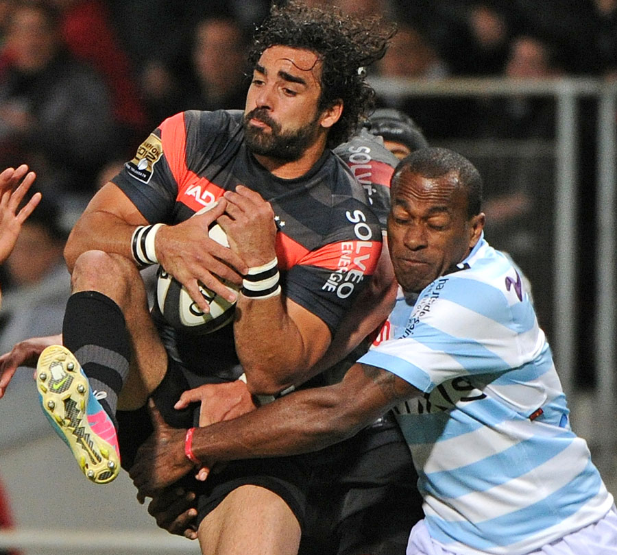 Toulouse's Yoann Huget is tackled by Racing Metro's Sireli Bobo