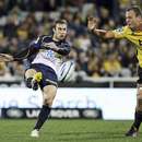 The Brumbies' Nic White clears the ball against the Hurricanes
