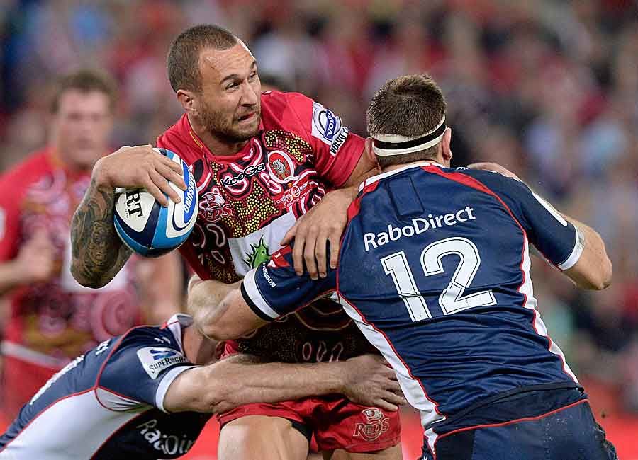 The Reds' Quade Cooper takes on the Rebels' defence