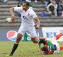 England's Luther Burrell off loads the ball in the tackle