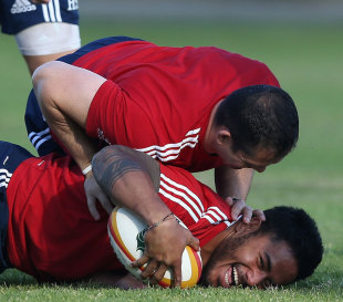 Who's boss? Manu Tuilagi is pinned down by defence coach Andy Farrell  during a  Lions training session, Langley Park, Perth, June 3, 2013