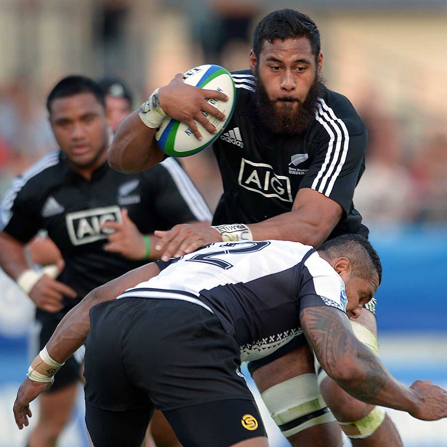 New Zealand's Patrick Tuipulotu is tackled by Fiji's Sevanaia Galala