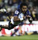 The Brumbies' Henry Speight dives over to score a try