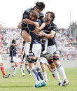 Japan's Michael Broadhurst is engulfed after scoring