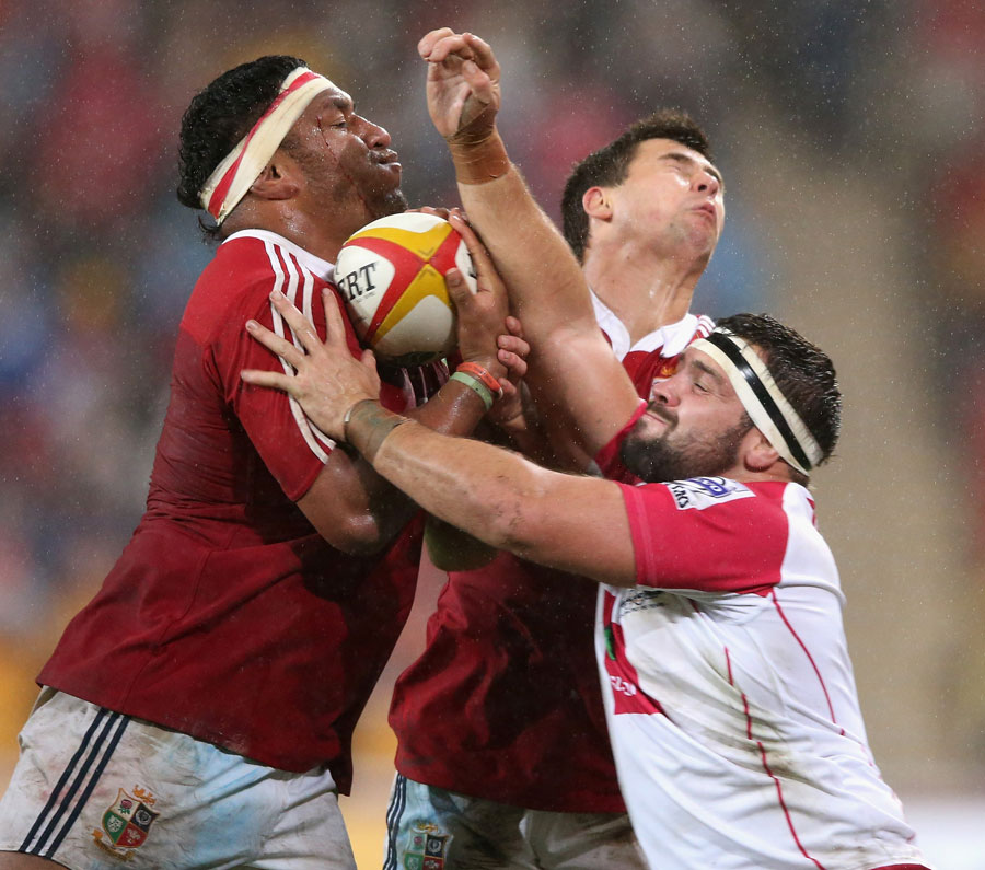 The Lions' Mako Vunipola and Ben Youngs and the Reds' James Hanson compete for the ball