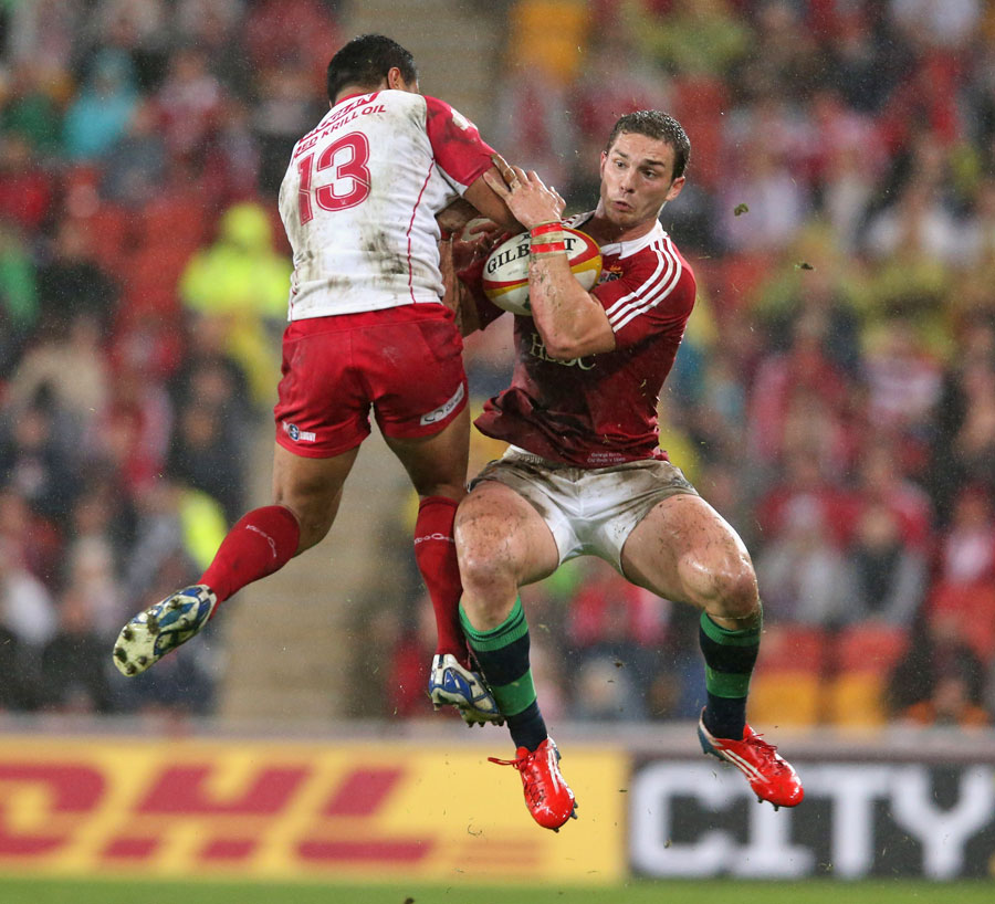 The Lions' George North and the Reds' Ben Tapuai vie for the ball