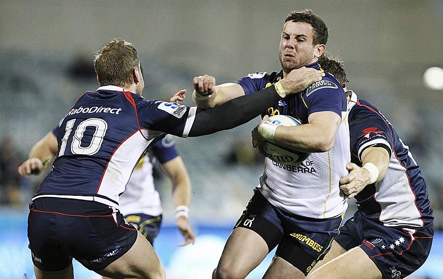 The Brumbies' Robbie Coleman runs through the Rebels' James O'Connor