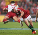 The Lions' Owen Farrell tackles the Reds' James Hanson 