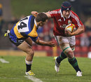 The Lions' Sean O'Brien fends off Combined Country's Alex Gibbon
