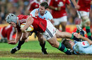 The Lions' Jonathan Davies is hauled down by the Waratahs' defence