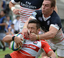 Japan's Toshiaki Hirose is tackled by the United States' Chris Wyles