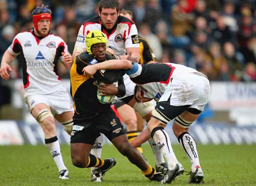 Wasps' Serge Betsen is tackled by Edinburgh's Jim Hamilton and Allistair Hogg