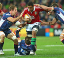 Lions No.8 Toby Faletau powers through the Rebels' defence