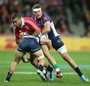 Lions winger Simon Zebo is tackeld by Rebels opposite Lachlan Mitchell
