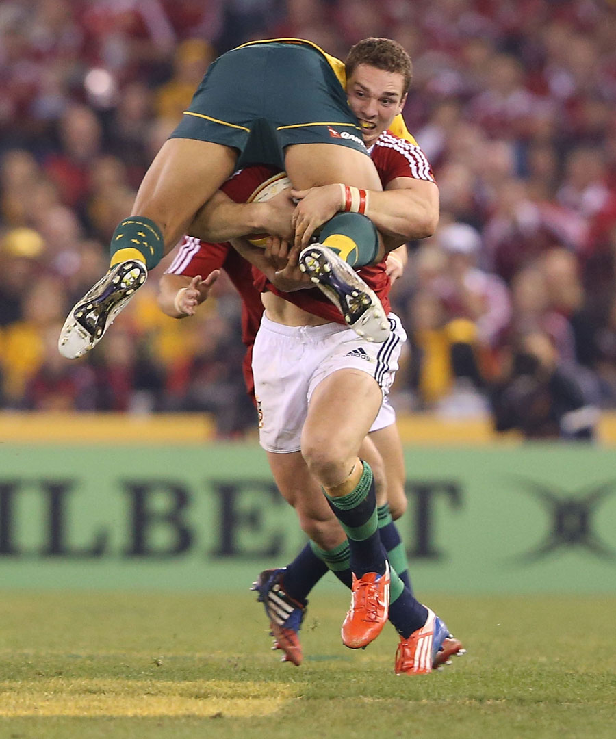 The Lions'  George North takes Australia's Israel Folau for a ride