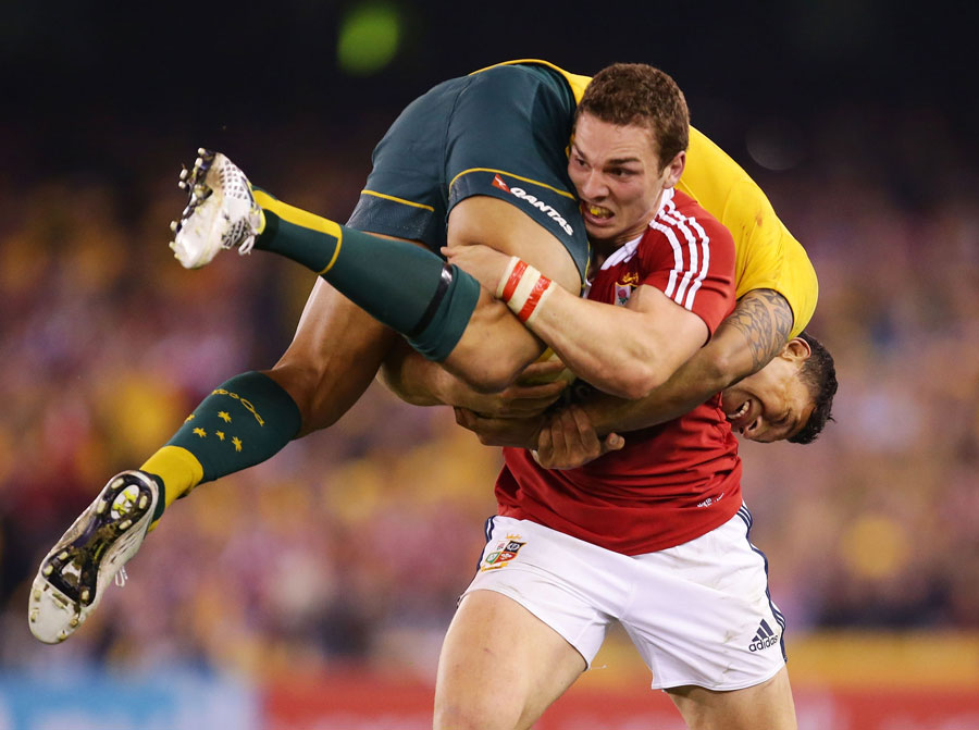 The Lions'  George North takes Australia's Israel Folau for a ride