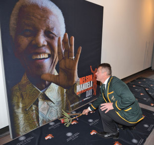 Springbok coach Heyneke Meyer lays flower during the launch of the Nelson Mandela Sports Day, Sandton Convention Centre, Johannsburg, July 4, 2013