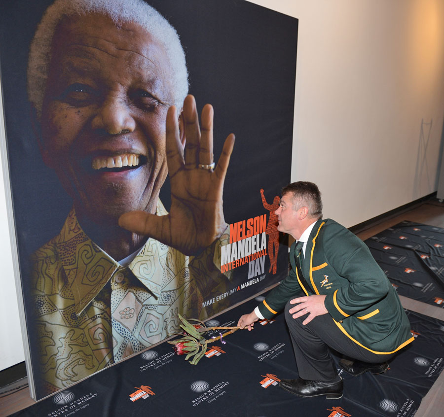 Springbok coach Heyneke Meyer lays flower during the launch of the Nelson Mandela Sports Day 