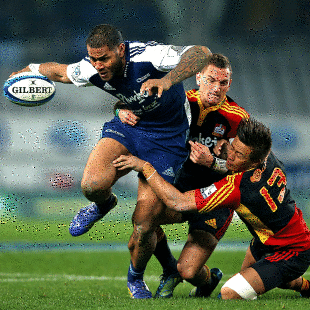 The Blues' Frank Halai runs through the tackles of Aaron Cruden and Tim Nanai-Williams, Blues v Chiefs, Super Rugby, Eden Park, Auckland, July 13, 2013