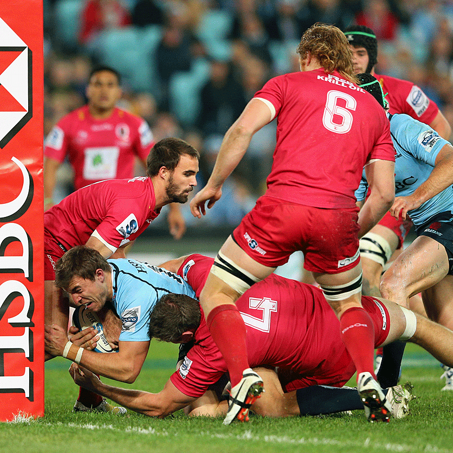 The Waratahs' Cam Crawford scores a try against the Reds