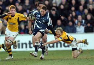 Sale Sharks' Luke McAlister evades the tackle of Wasps' Joe Simpson during their Guinness Premiership match at Edgeley Road in Stockport, Manchester on December 26, 2008. 