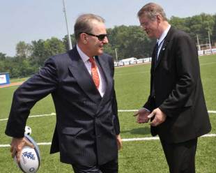 International Olympic Commitee Chairman Belgium's Jacques Rogge (L) passes the rugby ball to the International Rugby Board (IRB) Chairman France's Bernard Lapasset (R) during their visit at the newly inaugurated gymnastics, handball and tennis halls of the Romanian Olympic Preparation Center near Bucharest on May 28, 2008