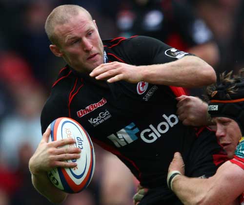Saracens wing Dan Scarbrough is tackled by Simon Easterby of the Scarlets