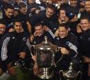 The All Blacks celebrate with the Tri-Nations trophy