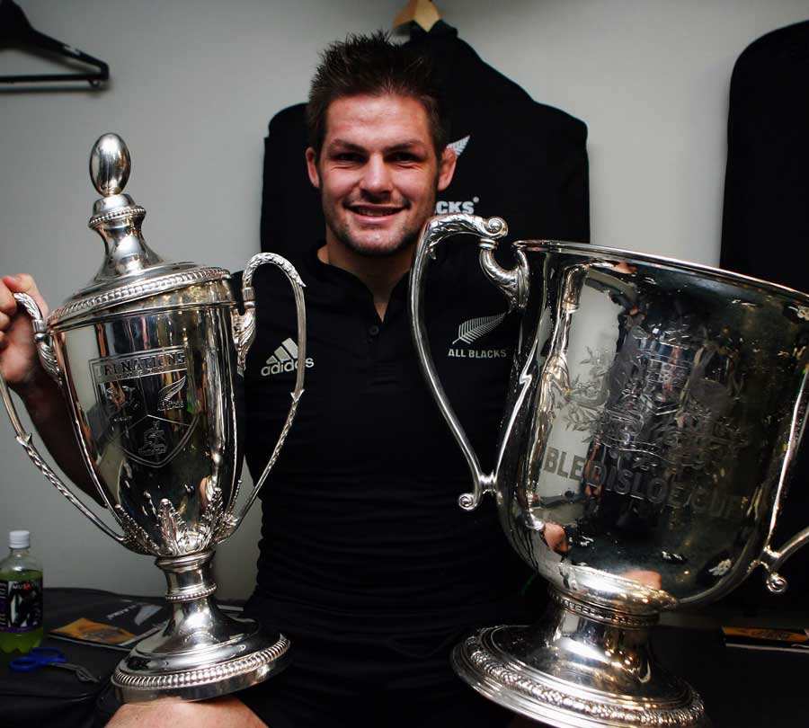 Richie McCaw celebrates with the Tri Nations trophy and Bledisloe Cup