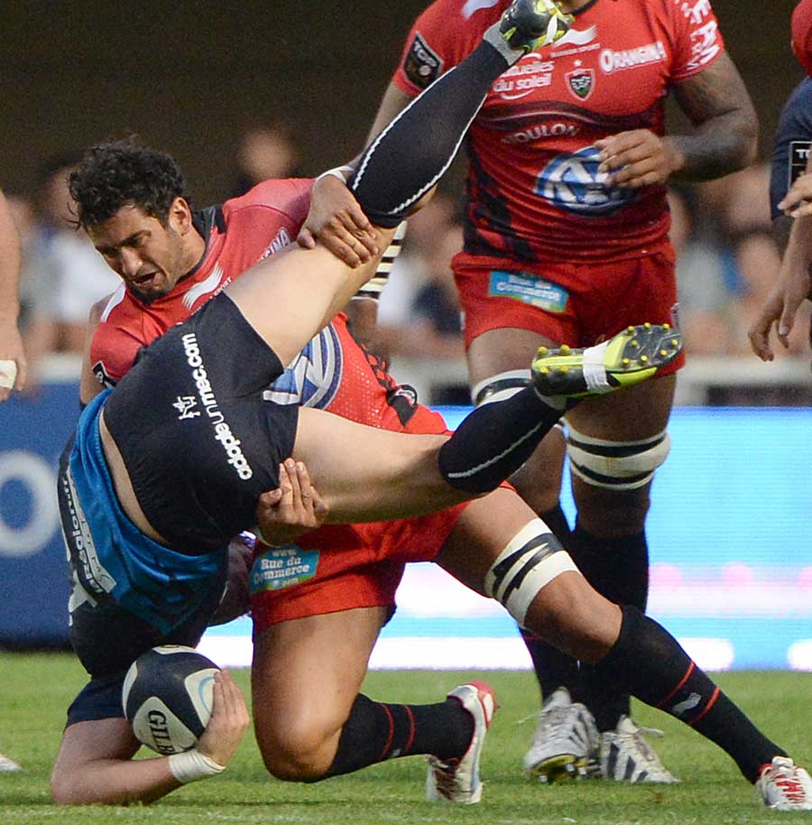 Toulon's Sebastien Tillous-Borde gets to grips with Wynand Olivier