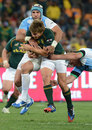 South Africa's Pat Lambie is engulfed by Argentina's Juan Manuel Leguizamon