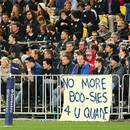 New Zealand fans display a banner on the fence
