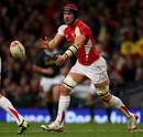 Wales' Jonathan Thomas wings the ball on