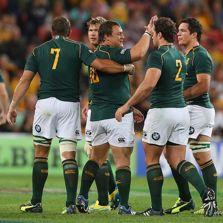 South Africa's Coenie Oosthuizen accepts team-mates' congratulations for a try