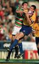 Bath's Matt Perry vies for the ball against Leicester's Will Greenwood