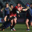 Canterbury's Ryan Crotty takes the tackle of Otago's Paul Grant and Fumiaki Tanaka