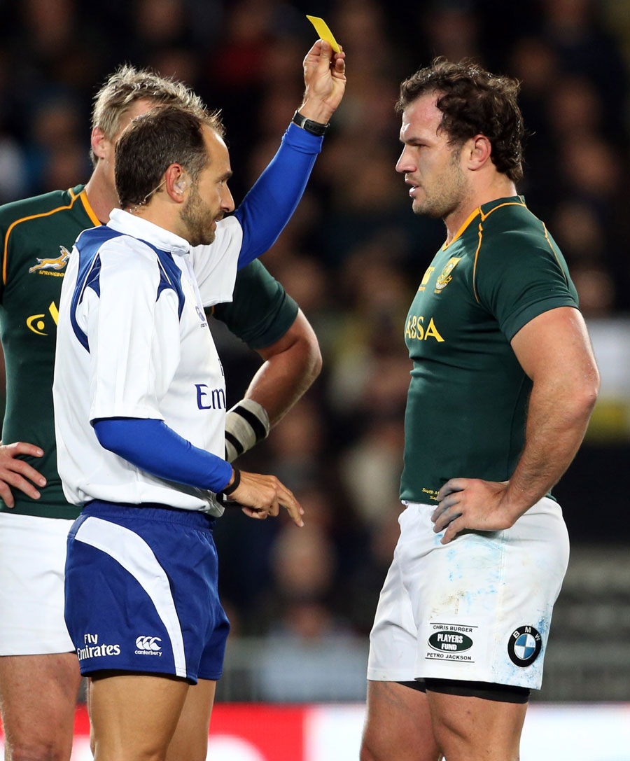 Referee Romain Poite shows South Africa's Bismarck du Plessis a yellow card
