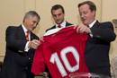 Prime Minister David Cameron is presented with a memento by the British & Irish Lions