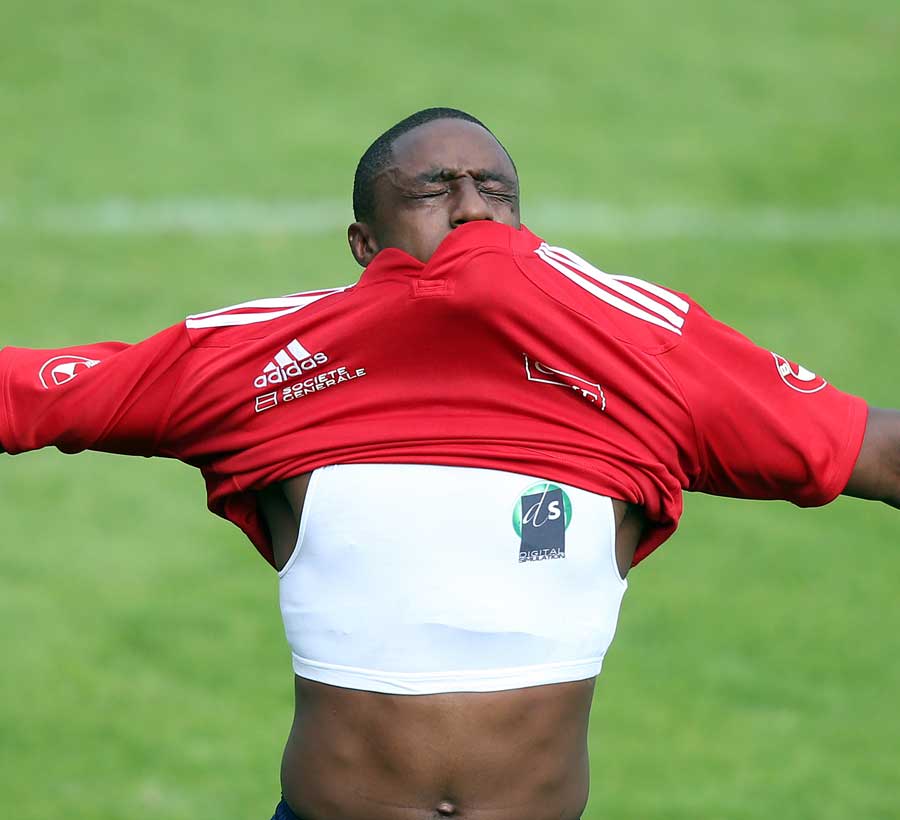 Yannick Nyanga struggles to get his top in training