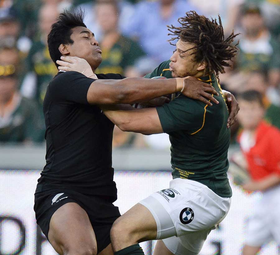 New Zealand's Julian Savea connects with South Africa's Zane Kirchner