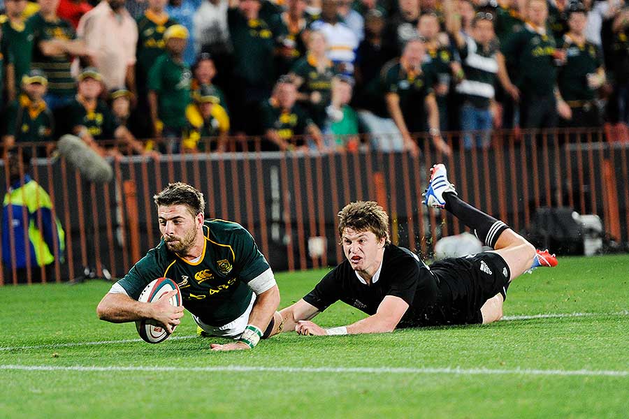 New Zealand's Beauden Barrett stops South Africa's Willie le Roux from scoring his second try
